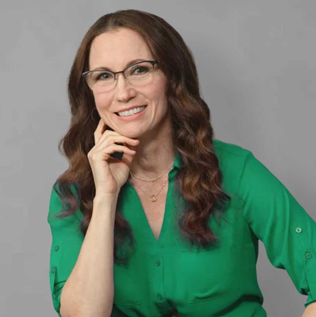 A portrait of Nicole Bonilla wearing a green blouse.